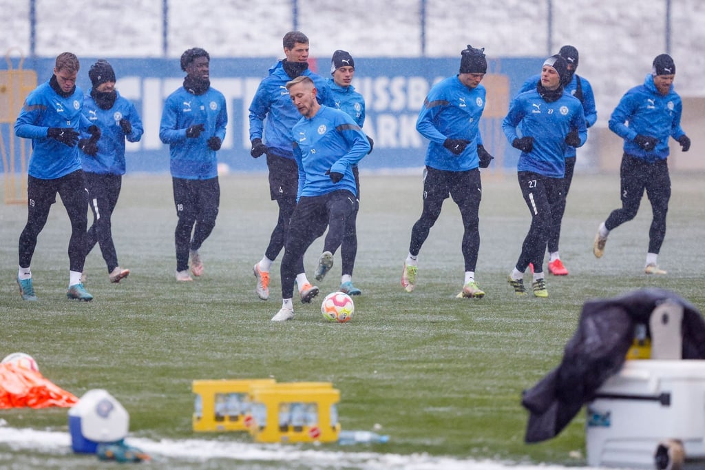Kiels Spieler wärmen sich beim ersten Training nach der Winterpause auf.