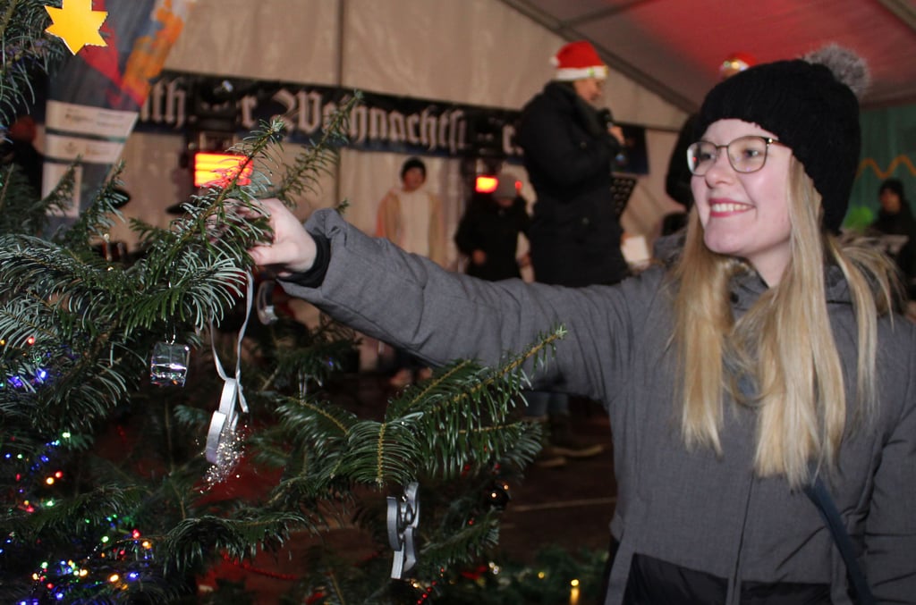 Mayen Miehe hängt einen Schmuckanhänger in den Spendenbaum: Wieder ist eine Spende eingegangen.