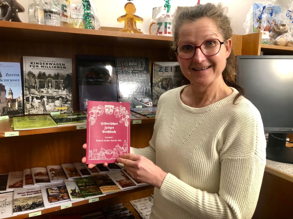 Annett Karge hat in der Tourist-Information das Kochheft vom Zeitzer Kochbuchverein vorrätig. Es ist das Jubiläumsheft zum 25. Vereinsjubiläum und enthält leckere Menü-Rezepte. Wer noch ein Geschenk sucht, kann auch im Angebot der Tourist-Information stöbern – von allerlei Gedrucktem über Zeitz-Souvenirs bis zu Handgemachtem.