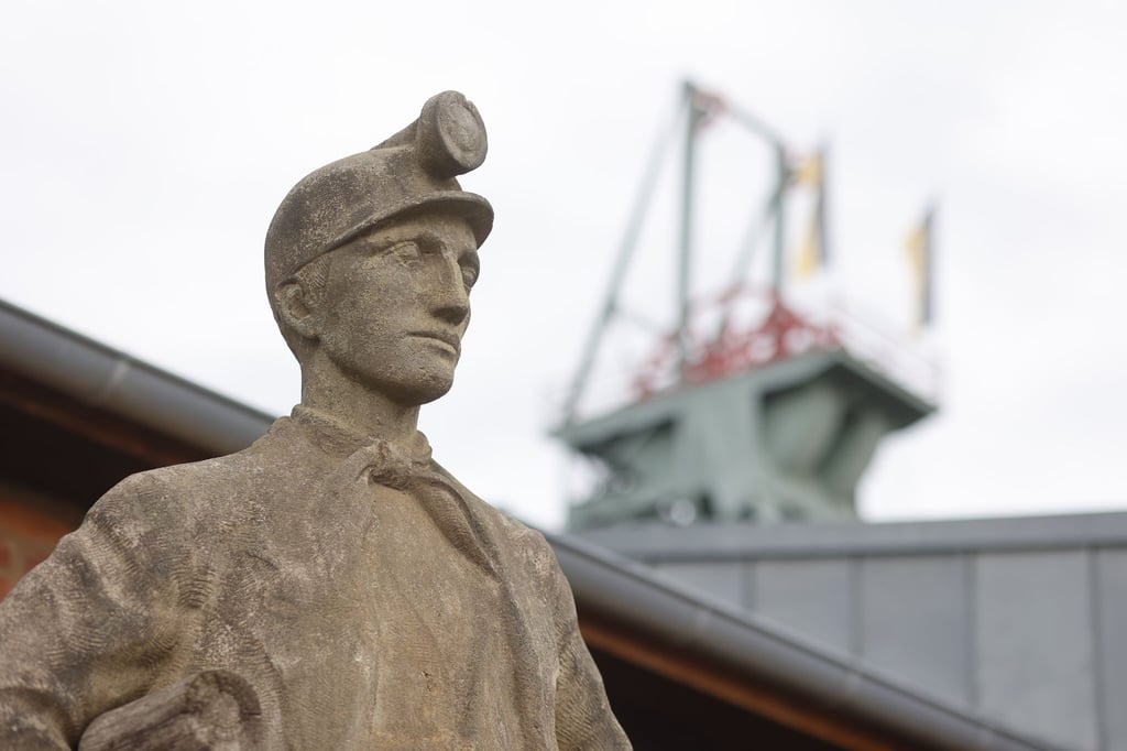 Eine Bergamannsfigur steht vor dem Eingang im Besucherbergwerk Röhrigschacht in Wettelrode.