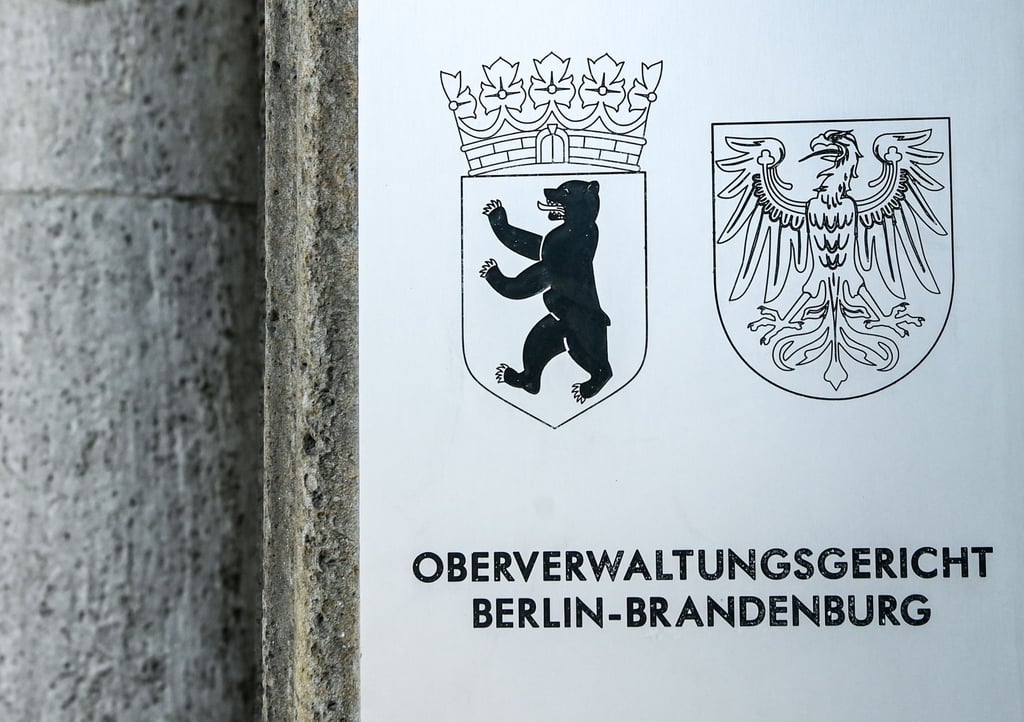 Oberverwaltungsgericht Berlin-Brandenburg steht am Eingang des Gerichtsgebäudes.