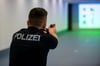 Ein Polizist der Berliner Polizei steht mit Übungswaffe im Schießstand.