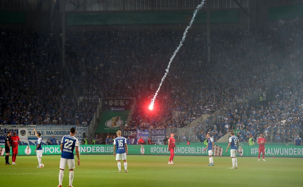 Ein Bengalo wird aus dem Frankfurter Fanblock auf das Spielfeld geworfen. Nun gibt es eine Strafe.
