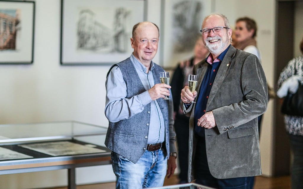 Jürgen Günsche (l.) und Michael Finger stoßen auf die Eröffnung der Ausstellung an.