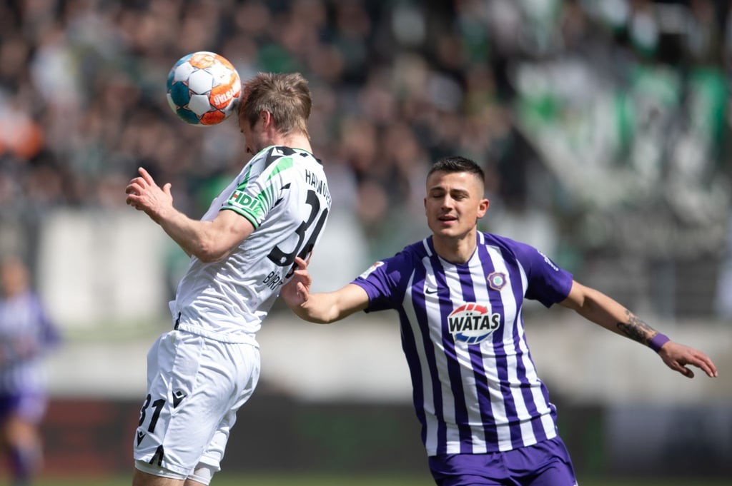 Hannovers Julian Börner (l) im Angriff gegen Aues Antonio Jonjic.