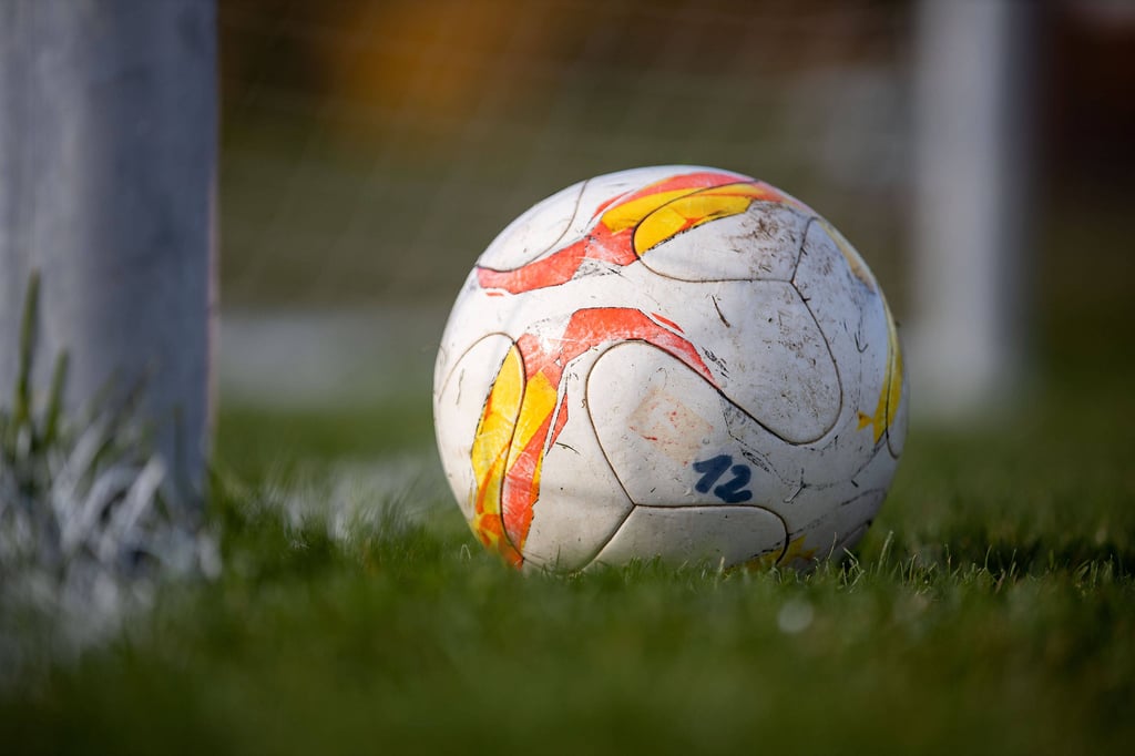 Ein Fußball an einem Torpfosten.