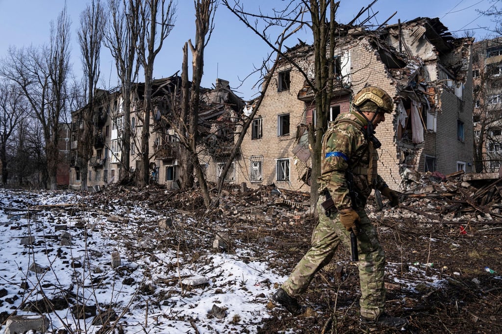Ein ukrainischer Soldat vor einem zerstörten Wohnhaus in der ostukrainischen Stadt Awdijiwka.