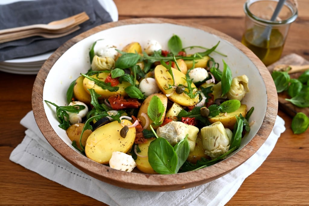Zu den Kartoffeln gesellen sich Artischocken, getrocknete Tomaten, Oliven, Mozzarella und Rucola.