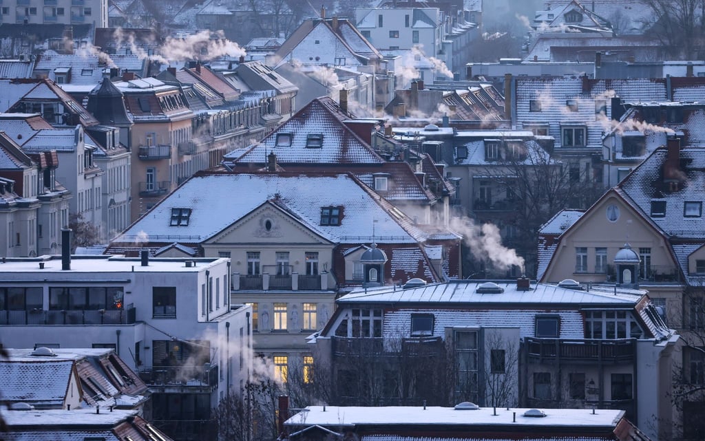 Qualm steigt aus den Schornsteinen und Abzügen an einem kalten Wintermorgen in der Leipziger Südvorstadt auf.