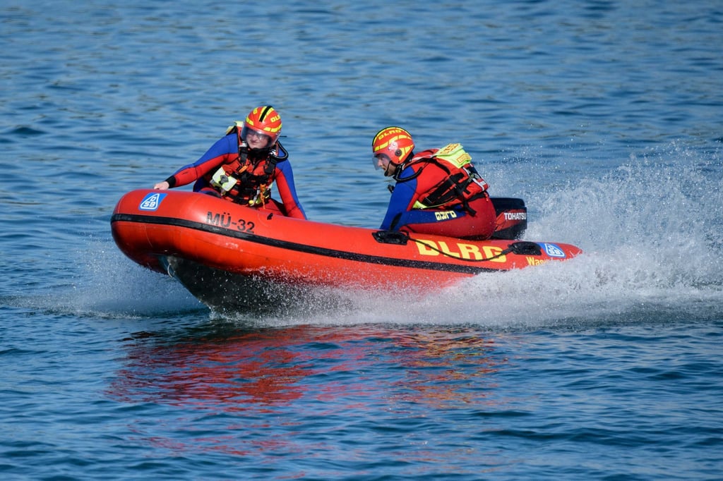 Wasserretter der Deutschen Lebens-Rettungs-Gesellschaft (DLRG) fahren in einem Schnellboot.