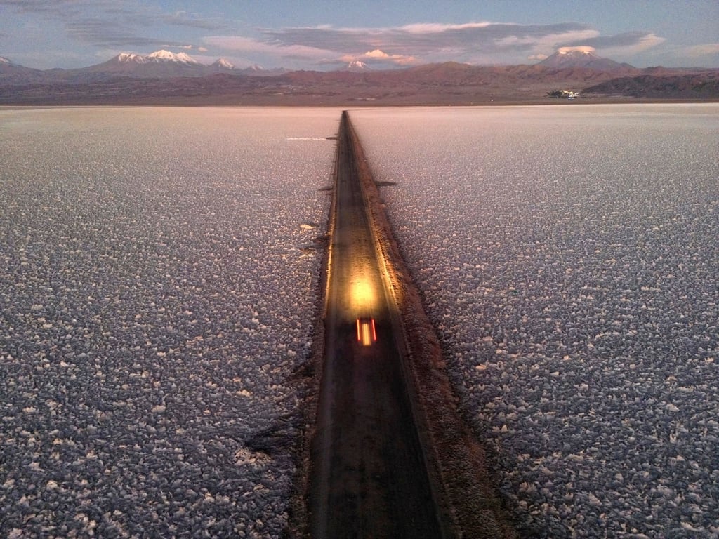 Ein Auto fährt auf einer Straße durch den Salar de Atacama in der Nähe der Lithiummine Albemarle in Chile.