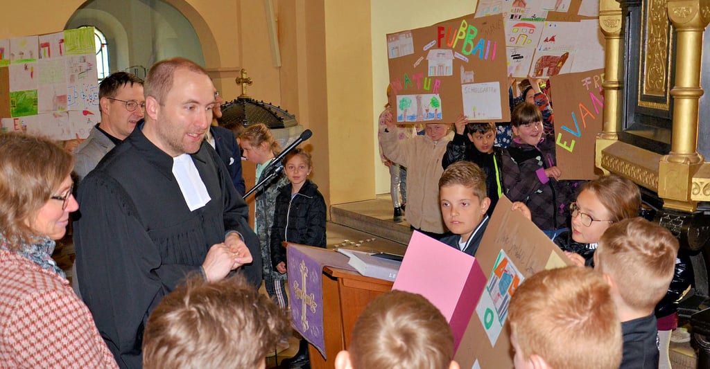 Von Fußball bis Schulgarten - die vier Klassen erklären den Gästen mit Pfarrer Kornelius Werner und mit Hilfe von Plakaten, was ihre Grundschule in Rathmannsdorf außer dem "normalen" Unterricht noch alles zu bieten hat.