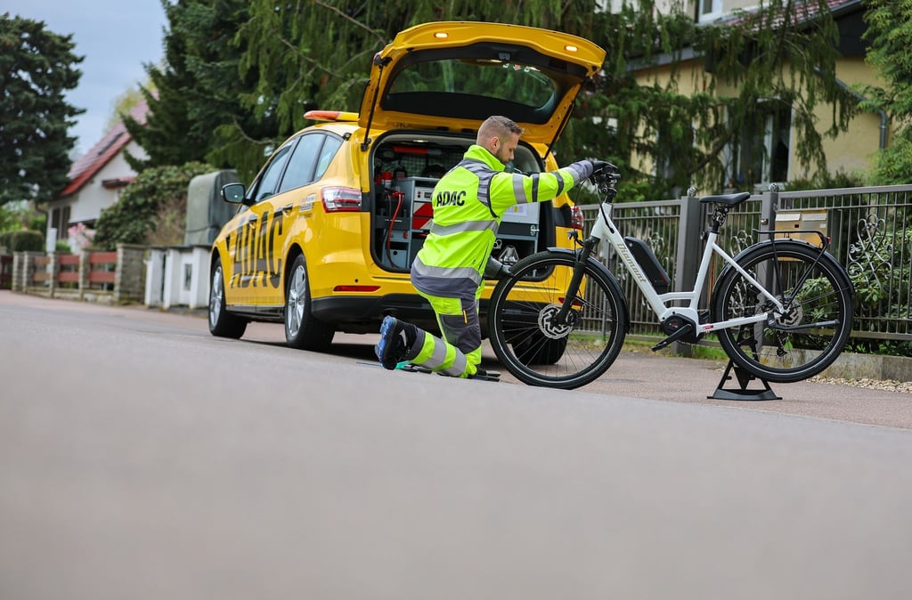 ADAC-Pannenhelfer Maik Musculus leistet Pannenhilfe an einem E-Bike.