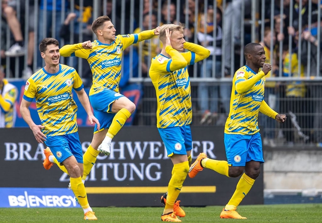 Braunschweigs Saulo Decarli (3.v-l) läuft jubelnd nach seinem Tor uum 1:0 in der 82. Minute über das Spielfeld.