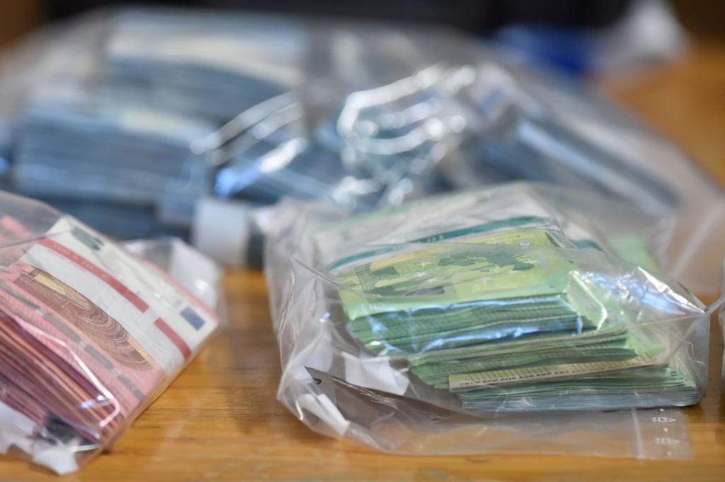 Sichergestelltes Bargeld liegt bei der Polizei auf einem Tisch.