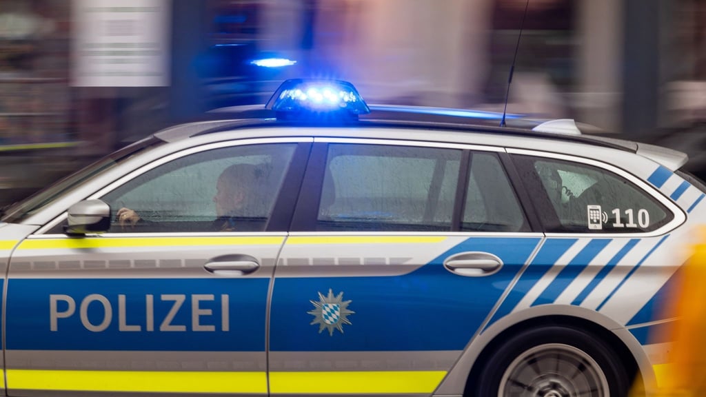 Ein Fahrzeug der Polizei fährt mit Blaulicht durch die Innenstadt.