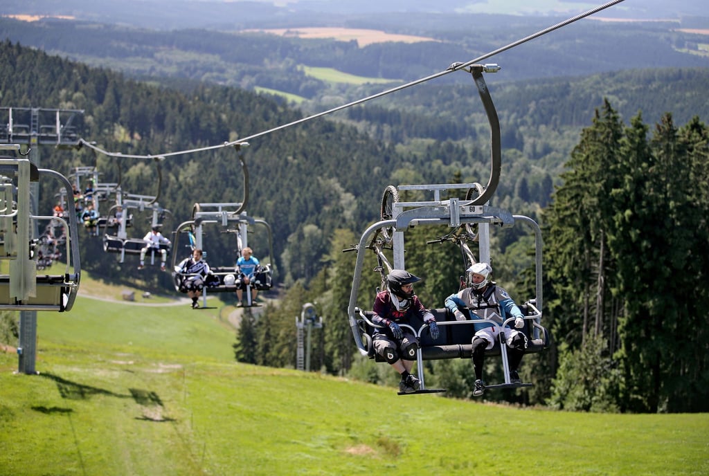 Mountainbiker fahren mit dem Sessellift der Bikewelt Schöneck/Vogtland (Sachsen).