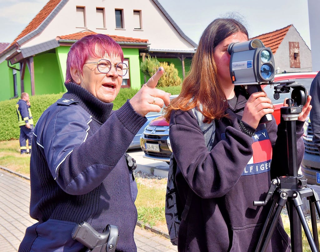 Polizistin Grit Kilian-Moritz erklärt Schülerin Jasmin die Geschwindigkeitsmessung per Laser. Nur eine von insgesamt 21 Stationen beim Verkehrserziehungstag an der Anne-Frank-Schule in Hettstedt.