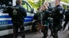 Sächsische Landtagsabgeordnete der Partei Die Linke Juliane Nagel wird von Polizisten zu einem Fahrzeug gebracht.