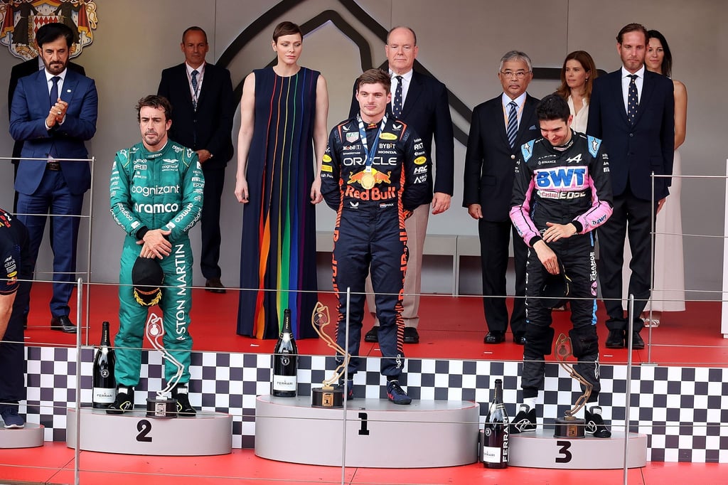 Monaco-Sieger Max Verstappen (M) steht zwischen dem Zweitplatzierten Fernando Alonso (l) und Esteban Ocon auf dem Siegerpodium.