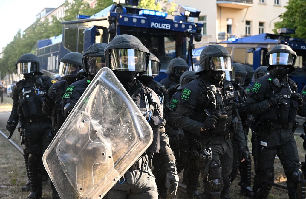 Polizei fährt Wasserwerfer zur Räumung einer Straße auf.