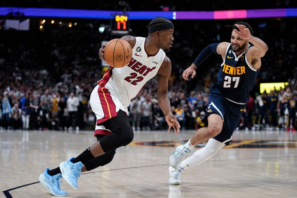 Miami Heat-Forward Jimmy Butler (l) bewegt den Ball, während er von Denver Nuggets-Guard Jamal Murray verteidigt wird.