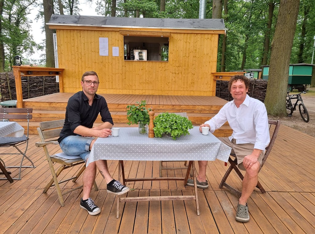 Koch Matthias Heider (links) und Campingplatz-Chef Olaf Christ eröffnen genau an diesem Platz auf dem Foto am Freitag dieser Woche eine Gastronomie. Im Hintergrund in einem umgebauten Bauwagen befinden sich die Küche und die Getränkeausgabe.