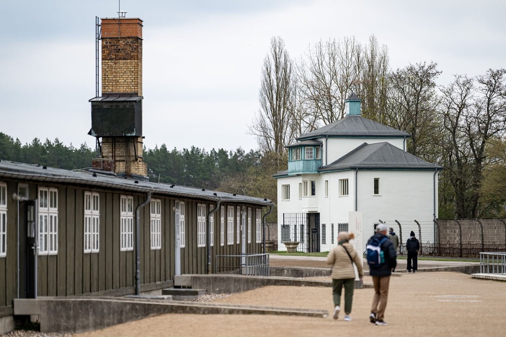 Personen laufen in der Gedenkstätte Sachsenhausen über das Gelände des ehemaligen Konzentrationslager.