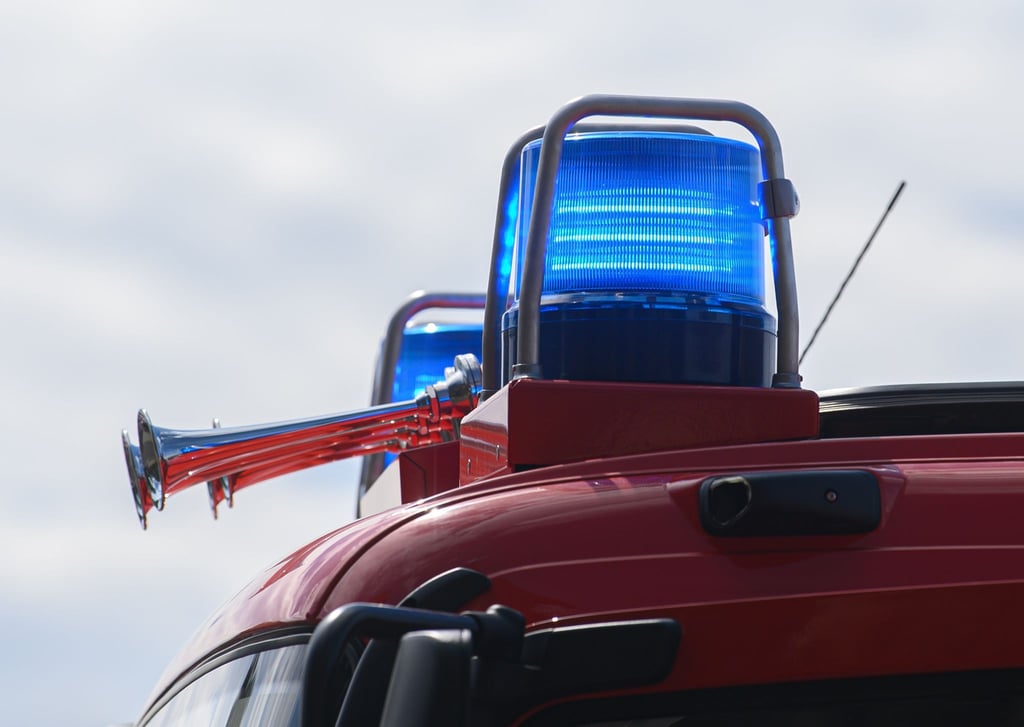 Blaulichter leuchten auf dem Dach eines Einsatzfahrzeugs der Feuerwehr.
