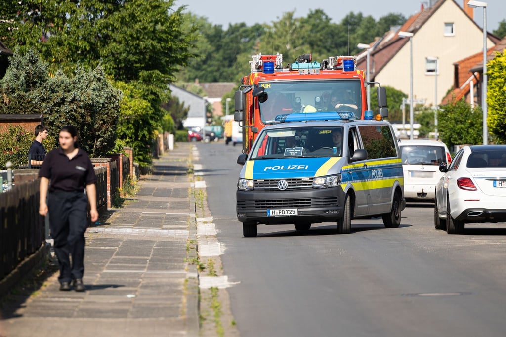 Einsatzkräfte von Feuerwehr und Polizei kontrollieren im Evakuierungsgebiet, dass Anwohner ihre Häuser verlassen.