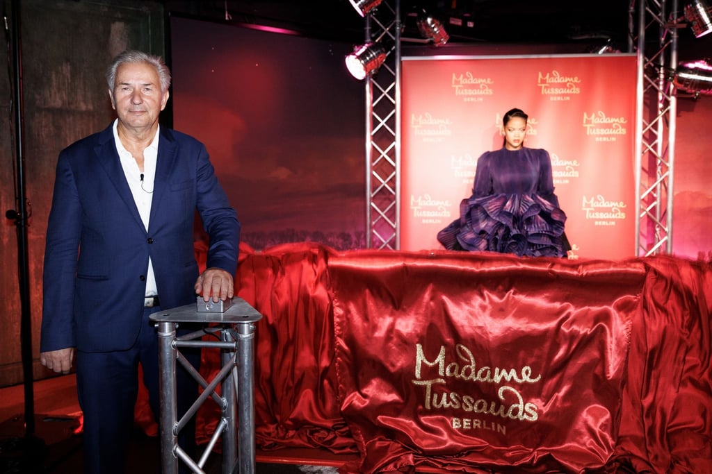 Klaus Wowereit (SPD) drückt einen Button, wodurch der Vorhang vor der neuen Rihanna-Wachsfigur fällt.