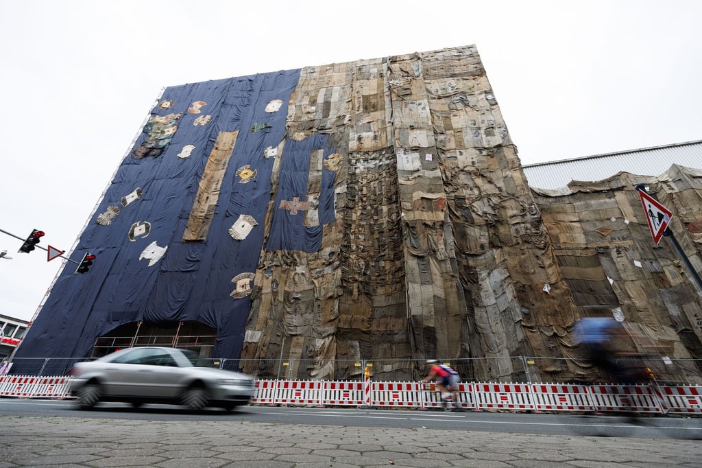 Gebrauchte Jutesäcke verhüllen die Fassade vom ehemaligen Galeria Kaufhof-Kaufhaus.