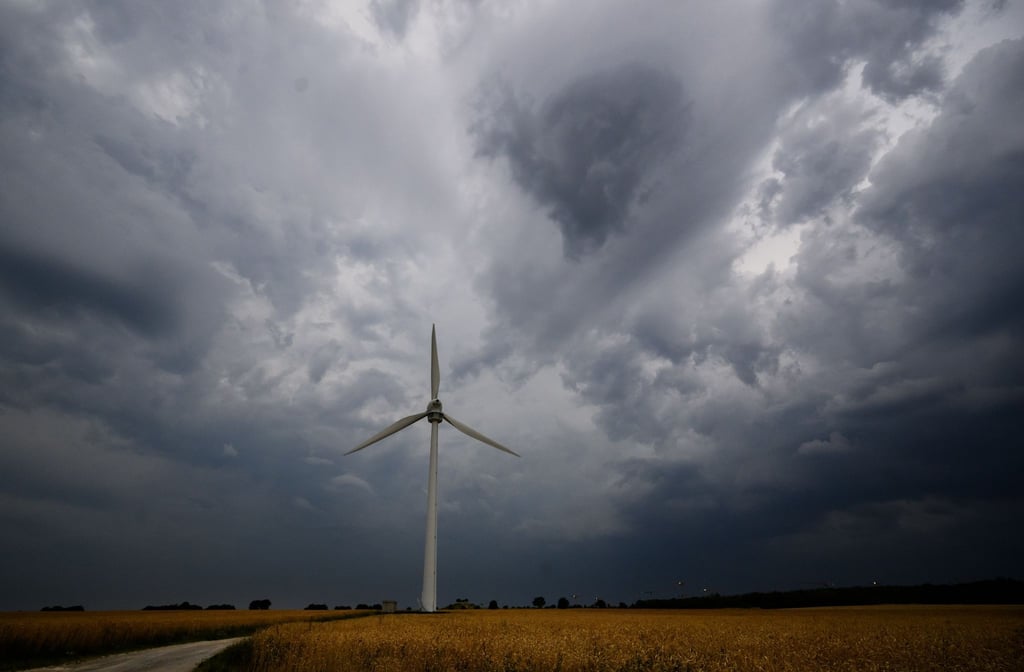 Dunkle Wolken ziehen über einem Windrad in der Region Hannover hinweg.