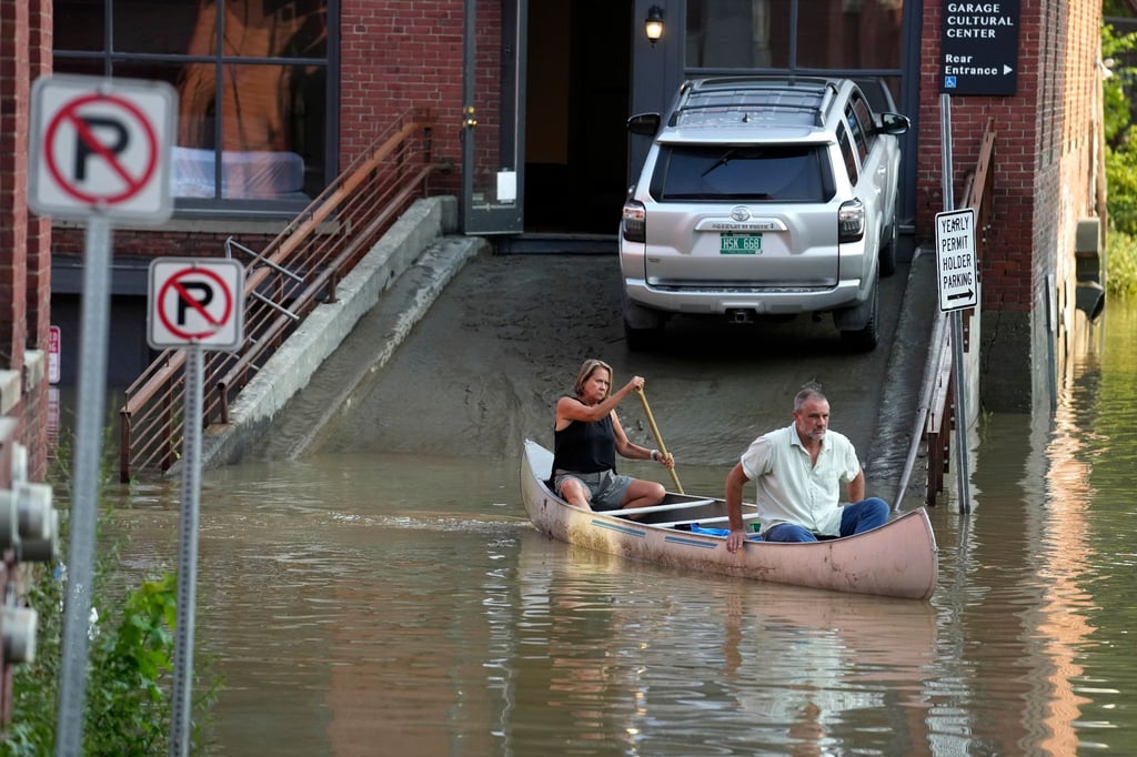 Ein Tierarzt und seine Mitarbeiterin transportieren per Kanu chirurgisches Material aus der von der Flut beschädigten Tierklinik in Montpelier.