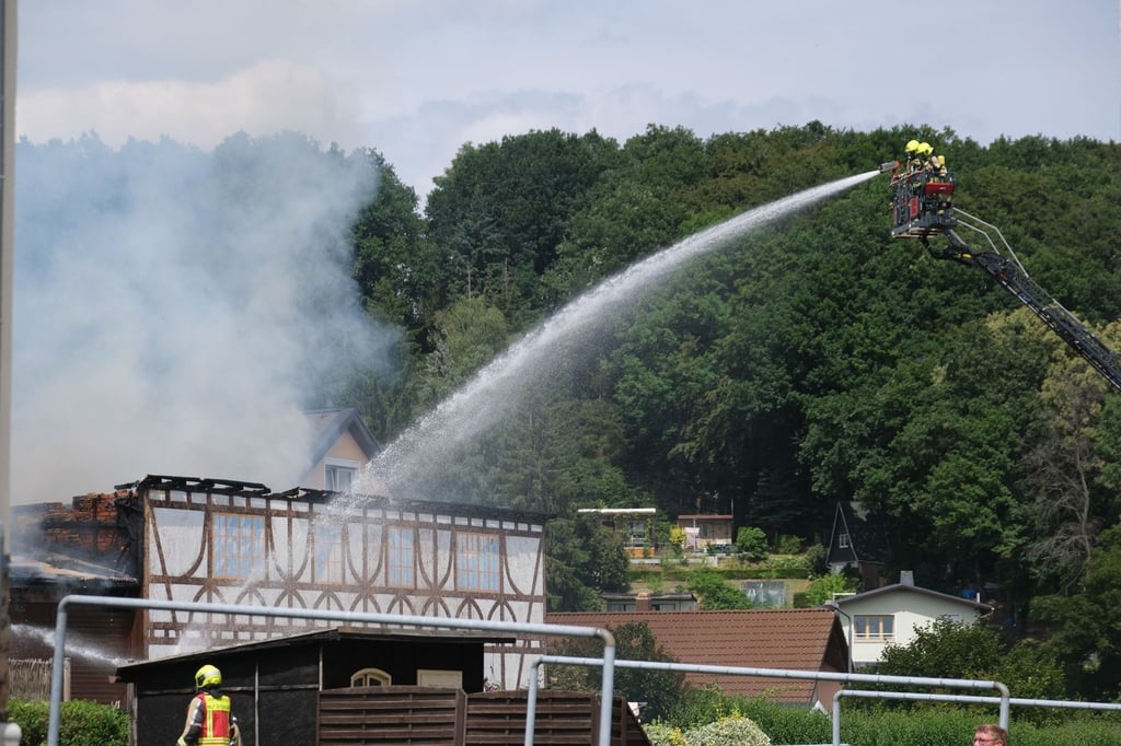 Feuerwehrleute bekämpfen einen Brand in einer Scheune im Ortsteil Wüstenbrand.