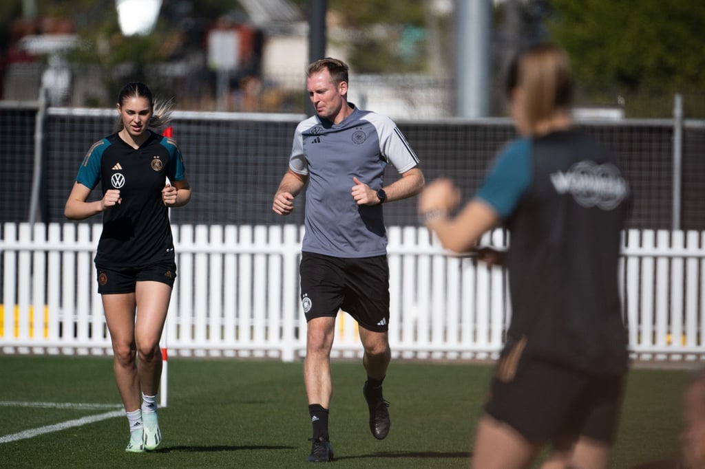 Jule Brand (l) trainiert am Rand des Trainingsplatzes.