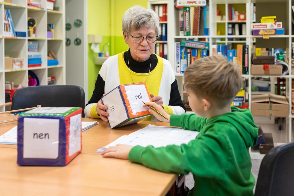 Sabine Otto ist eine der Mentorin, die Förderunterricht an der Droyßiger Grundschule erteilt. Hier hilft sie einem Erstklässler.