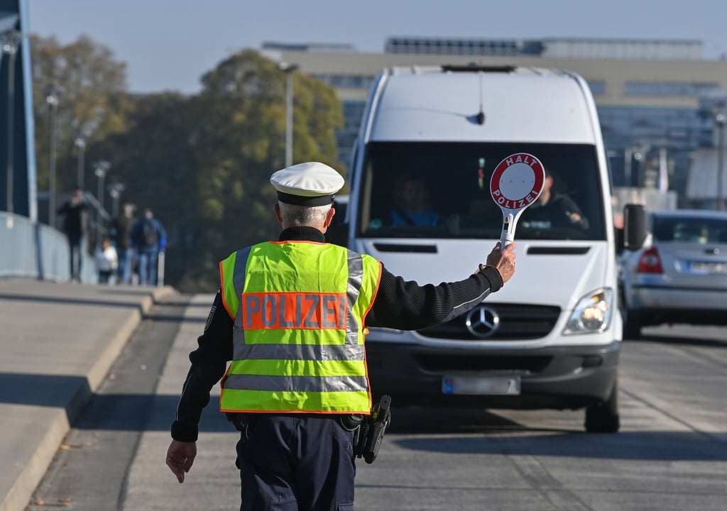 Ein Beamter der Bundespolizei stoppt den Fahrer eines Kleintransporters an einem deutsch-polnischen Grenzübergang.