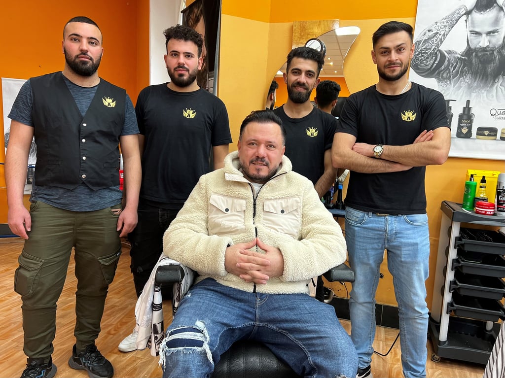 Arkan Akram Ghulam (m.) mit seinem Team im Merseburger Barbershop.