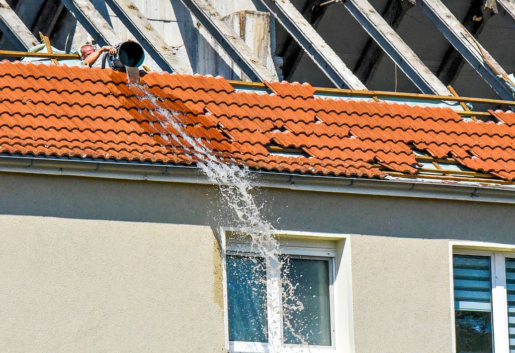 Das Wasser auf dem Dachboden wird nun abgesaugt, um zu verhindern, dass das Haus weiter voll läuft.