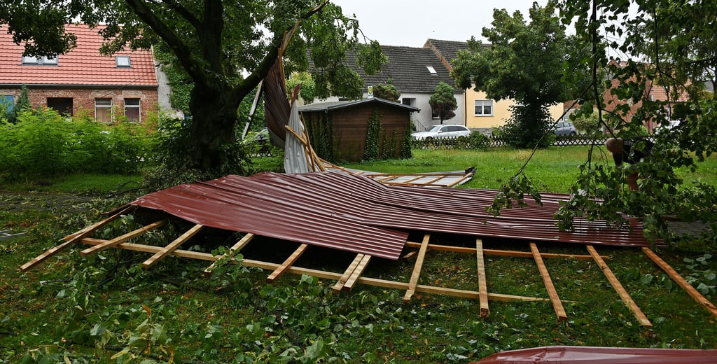 Dieses Scheunendach flog in Buhlendorf etwa 150 Meter über zwei Häuser (Hintergrund) hinweg, über die Straße, die Bushaltestelle und es landete im Park. Buhlendorf scheint es besonders getroffen zu haben. Auch zahlreiche Bäume stürzten um.