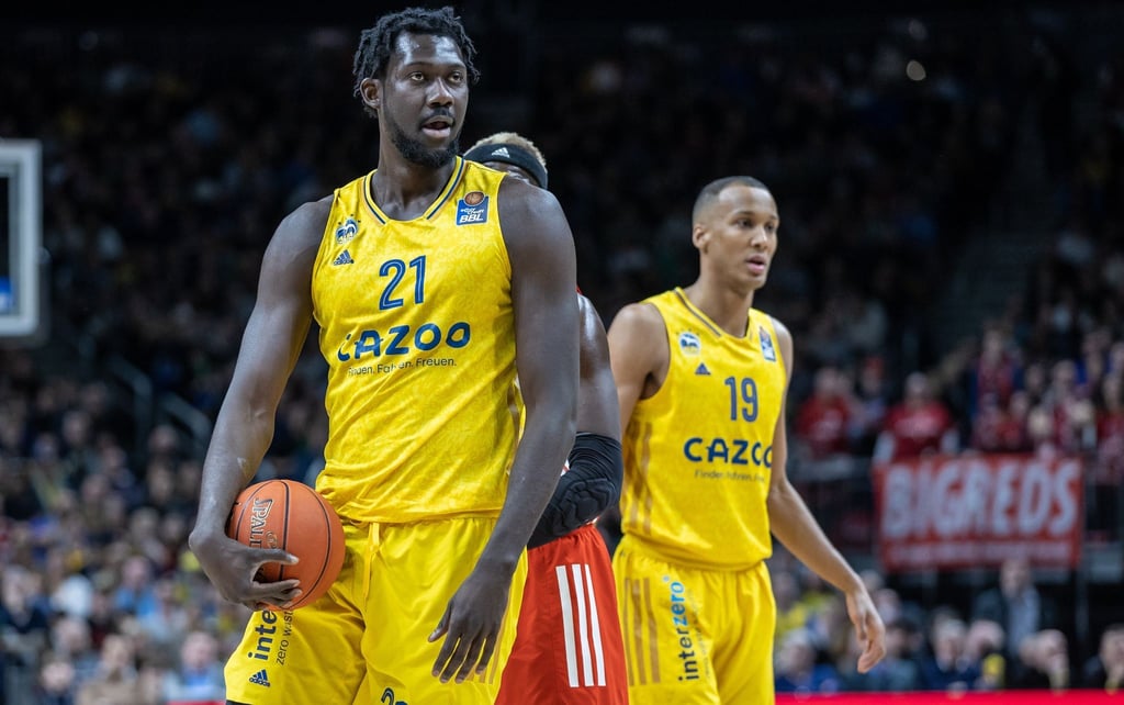 Albas Christ Koumadje (l) steht mit einem Ball auf dem Court in Berlin.
