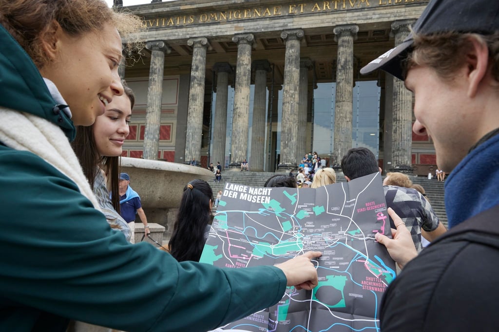 Teilnehmer der „Langen Nacht der Museen“ orientieren sich an einem Plan für die Museumsnacht.