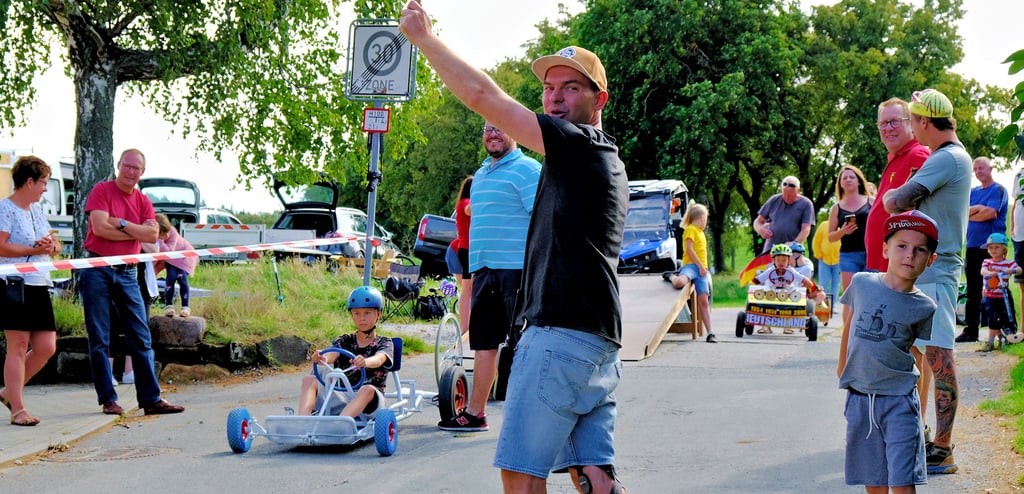 Starter Marco Manthey schickt in Derenburg Seifenkistenpilot Oskar Adlich auf die Strecke.