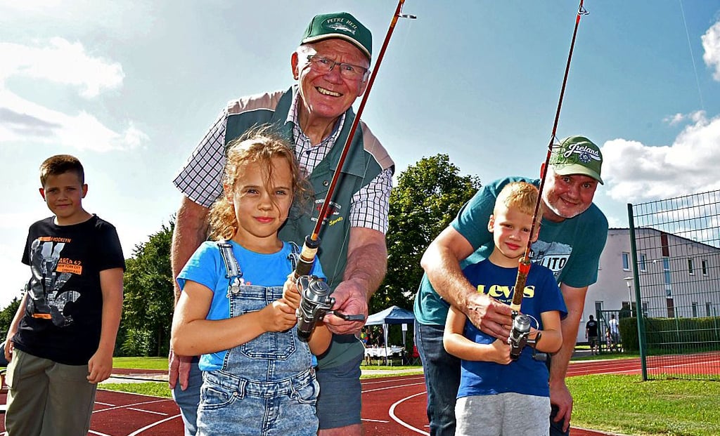 Die Petrijünger Friedhelm Müller und Sohn Michael, der der Vorsitzende der Calvörder Anglergruppe ist, zeigen der fünfjährigen Malou und dem gleichaltrigen Pepe, wie der Casting-Sport (Trockenangeln) funktioniert.