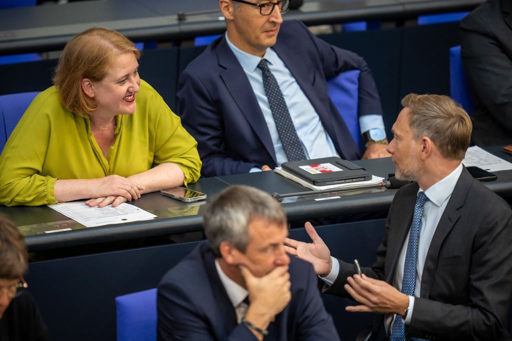 Finanzminister Christian Lindner (FDP) spricht im Bundestag mit Familienministerin Lisa Paus (Grüne).