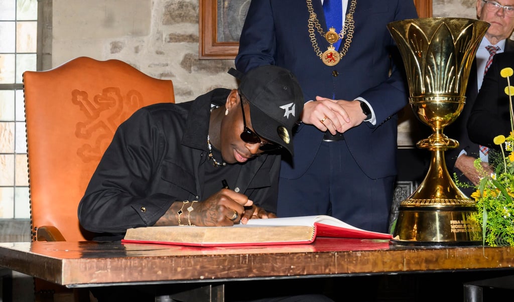 Dennis Schröder trägt sich in das goldene Buch der Stadt Braunschweig ein.