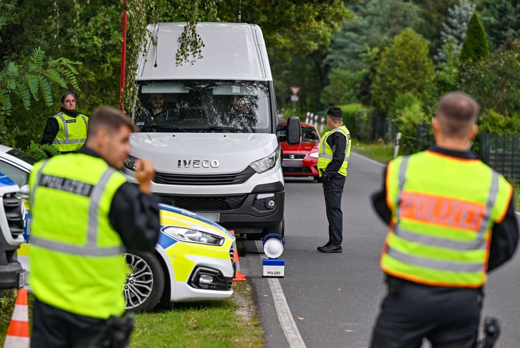 Polizeibeamte überprüfen einen Kleintransporter bei einer Kontrolle gegen Schleuserkriminalität.