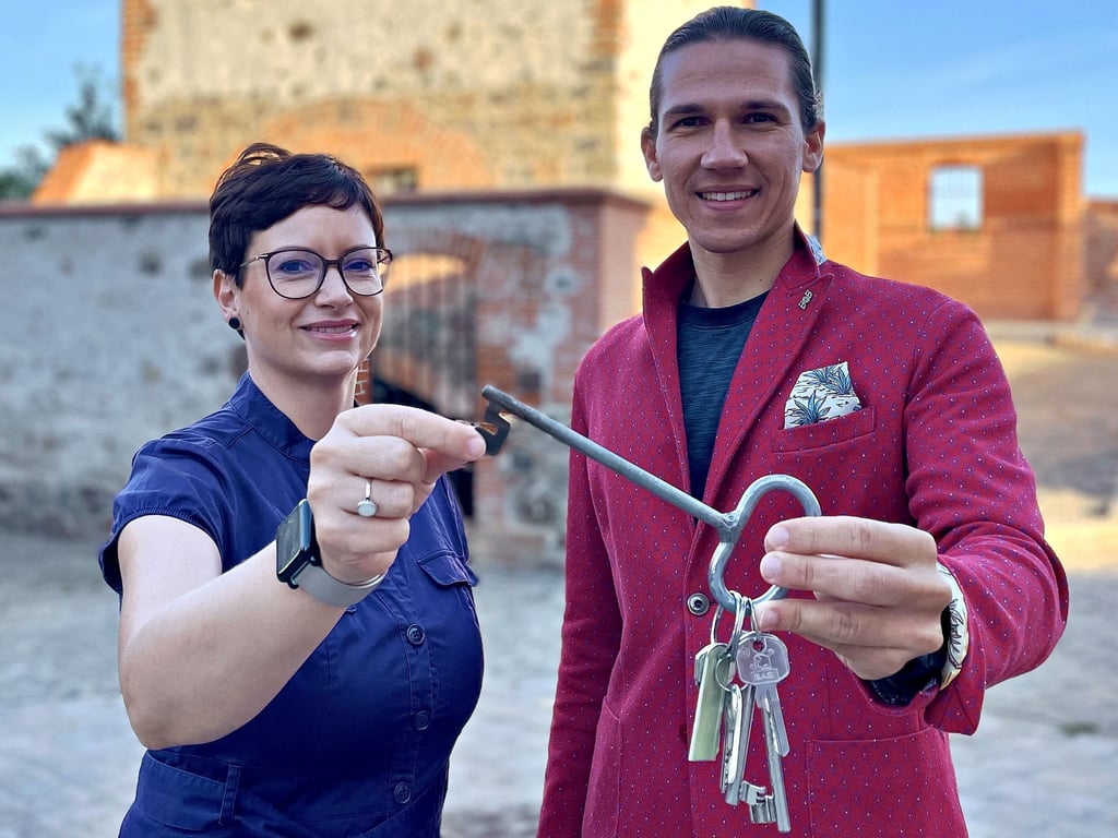 Stefanie Deckert, Sachgebietsleiterin Tourismus der Stadt Burg, und Fachbereichsleiter Maximilian Steib eröffnen mit dem symbolischen Schlüssel den Buchungsstart für die Türmeführungen.