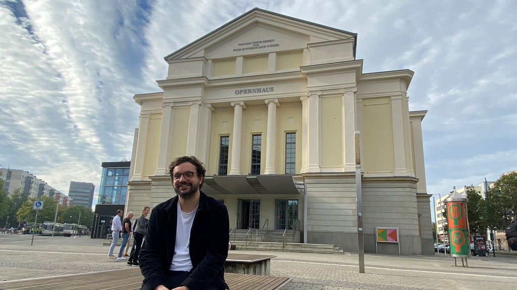 Der Generalintendant Julien Chavaz vor dem Magdeburger Opernhaus. Die vordere Fassade hat nach 30 Jahren einen Neuanstrich bekommen und strahlt jetzt in einem cremigen Gelbton.